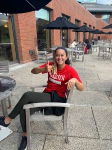 Robi Frederick sitting on a chair outside giving a thumbs up